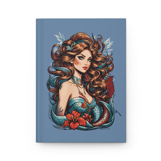 Notebook with a tattoo style mermaid design on a blue background