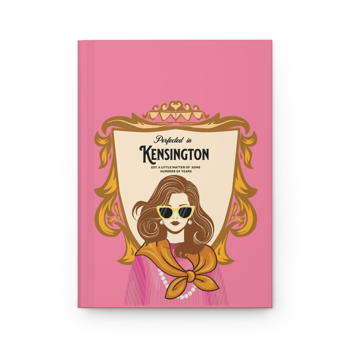 Notebook with a pink cover featuring an illustration of an English girl with a Chelsea blowout, wearing pearls and a scarf and sunglasses and regal aesthetic text "perfected in Kensington" written on a a coat of arms