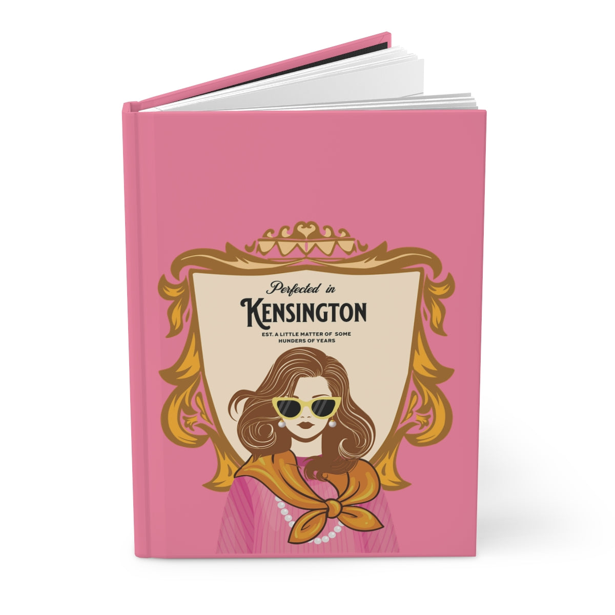 Notebook with a pink cover featuring an illustration of an English lady with a Chelsea blowout, wearing pearls and a scarf and sunglasses and regal aesthetic text "perfected in Kensington" written on a a coat of arms