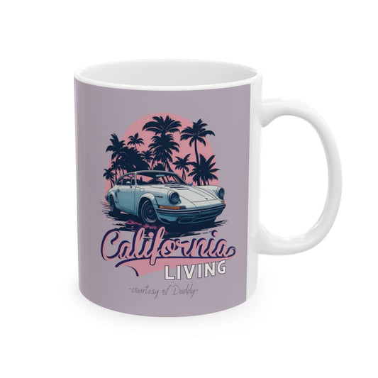 Pastel colored Mug with a design of a luxury sports car, palm trees, pink sunset,  and pastel pink retro aesthetic 'California Living' "curtesy of daddy" text on a pastel  purple background.
