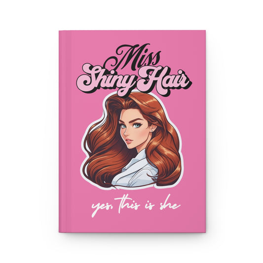 Pink Notebook with a y2k style retro illustration of a young brunette woman with bombshell blowout hair and 'Miss Shiny Hair' text in light pink retro aesthetic letters
