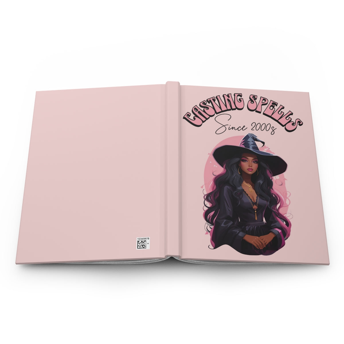 Open hardcover notebook with a light pink cover featuring an illustration of a beautiful black girl in a witch hat and text written in retro groovy style 'Casting Spells Since 2000s'.