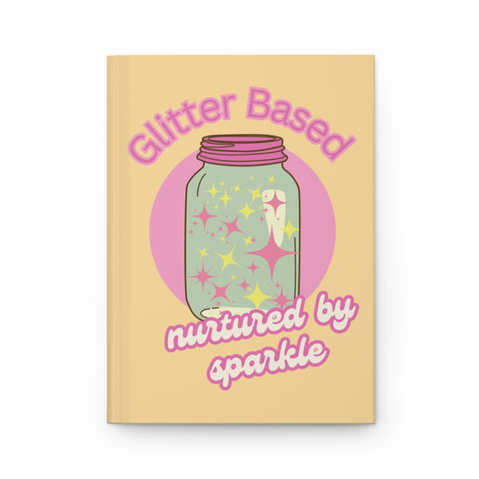 Pastel yellow notebook with a retro style mason jar with a pink lid illustration filled with pastel pink and yellow glitter and "glitter based, nurtured by sparkle" text written in pastel colored retro aesthetic letters