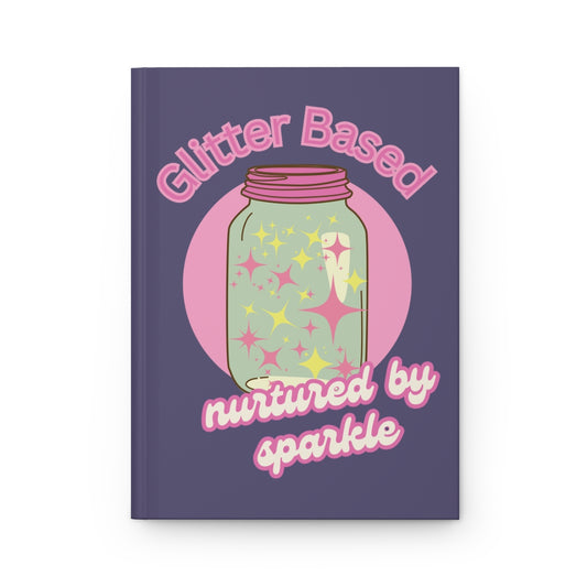 Notebook with an illustration of a pastel colored retro aesthetic mason jar filled with pink and yellow sparkle and retro style pink text "glitter based nurtured by sparkle" on a purple background